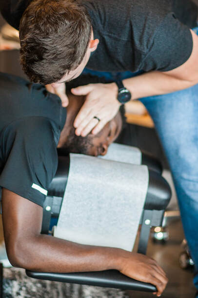 checking neck alignment on male client